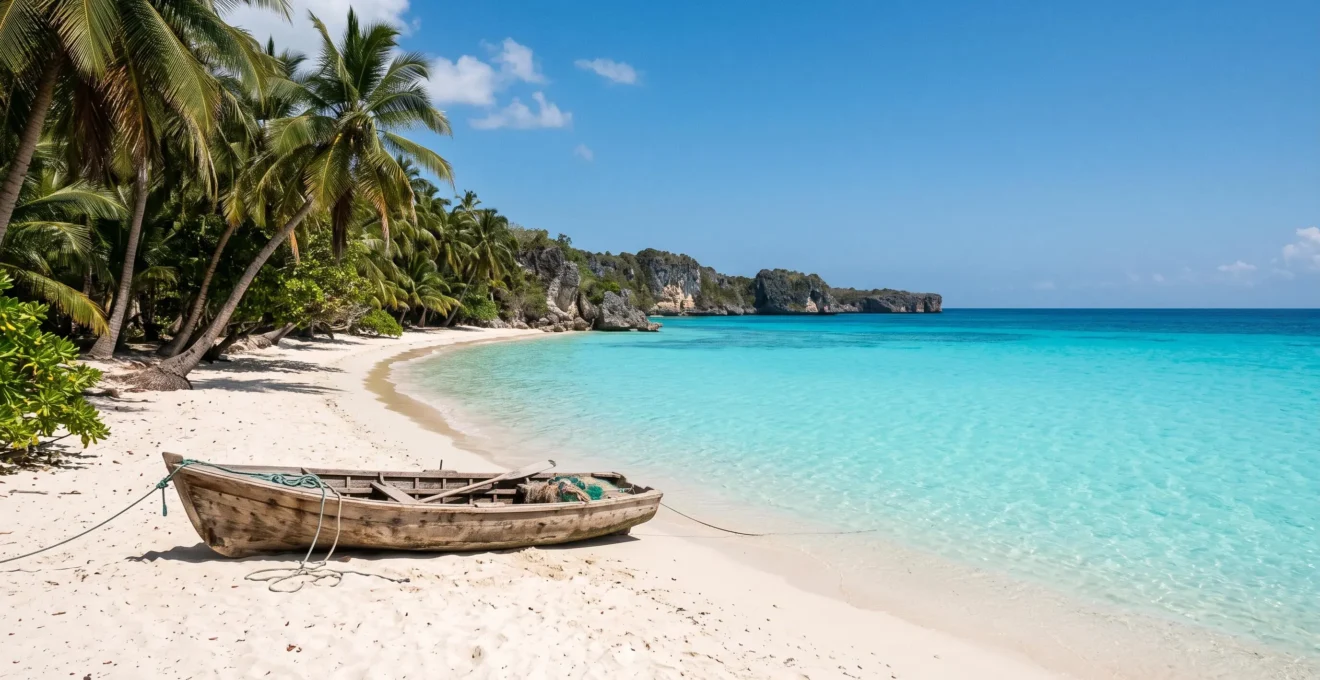 Wide view of an untouched turquoise cove on the Dominican Republic's coastline with white sand and limestone cliffs, free of crowds or structures